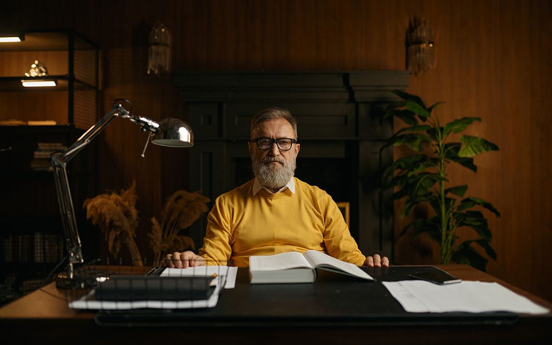 Portrait of serious pensive senior man on retirement working at home office