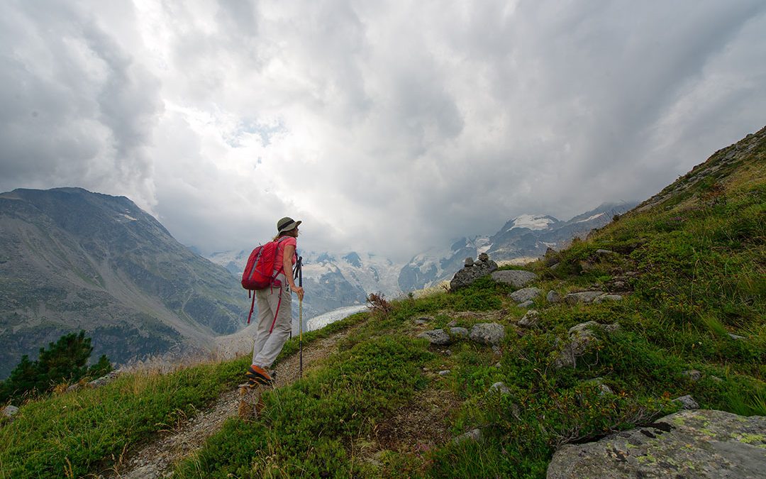 Retired woman practices a hike in the high mountains